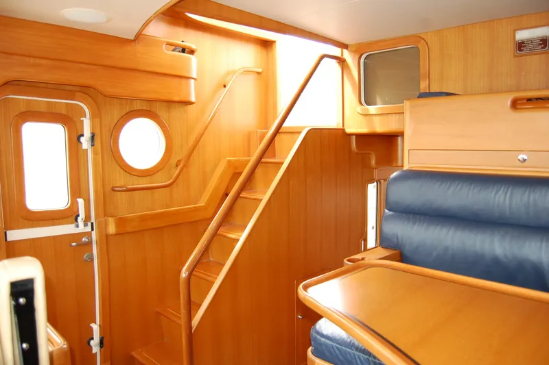 Blue Red Yacht Photos Pics Interior of 2006 Selene Pilothouse Ocean Trawler with wooden stairs and seating.