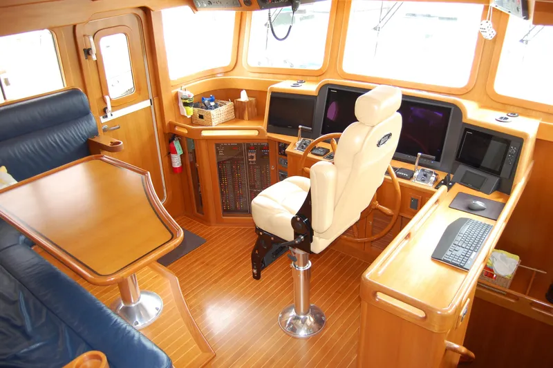 Blue Red Yacht Photos Pics Pilothouse interior of 2006 Selene Pilothouse Ocean Trawler with navigation equipment and seating.
