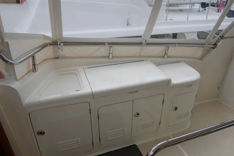 Blue Red Yacht Photos Pics 2006 Selene Pilothouse Ocean Trawler deck with storage compartments and railing.