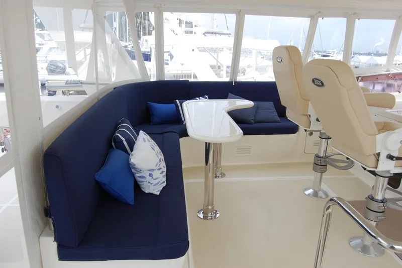 Blue Red Yacht Photos Pics Pilothouse interior of 2006 Selene Ocean Trawler with blue seating and helm chairs.
