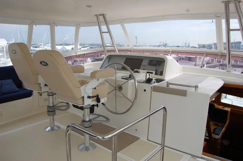 Blue Red Yacht Photos Pics Pilothouse interior of 2006 Selene Ocean Trawler with dual helm seats and navigation equipment.