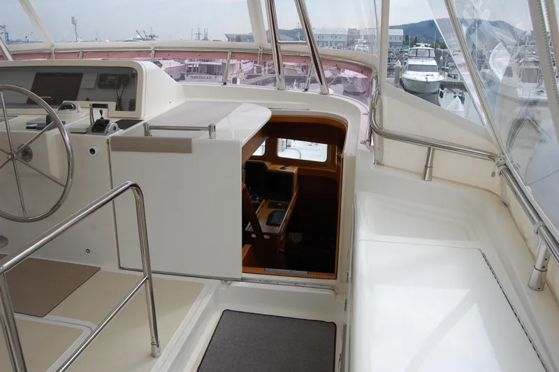 Blue Red Yacht Photos Pics 2006 Selene Pilothouse Ocean Trawler helm with steering wheel and navigation equipment.