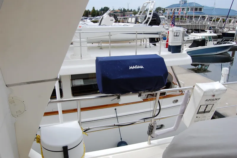 Blue Red Yacht Photos Pics 2006 Selene Pilothouse Ocean Trawler docked, featuring deck equipment and marina background.