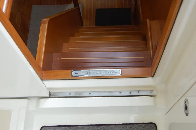 Blue Red Yacht Photos Pics Wooden stairs inside 2006 Selene Pilothouse Ocean Trawler, featuring engraved nameplate.