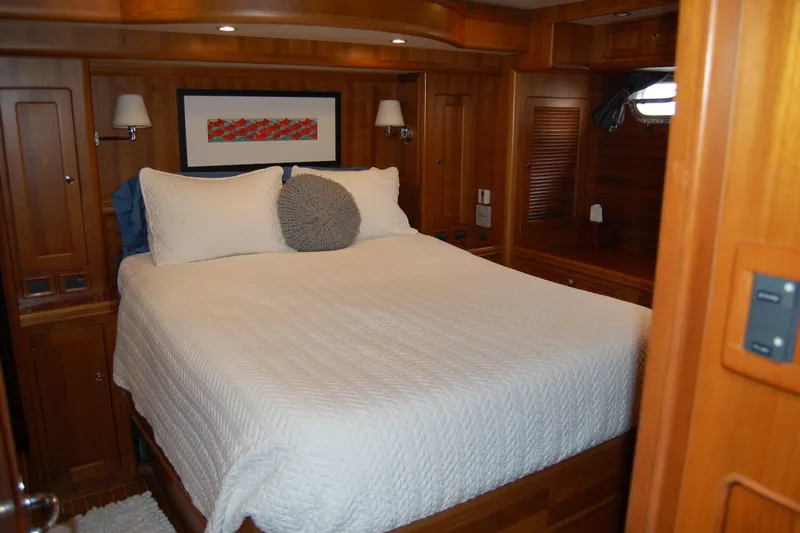 Blue Red Yacht Photos Pics Luxurious cabin interior of 2006 Selene Pilothouse Ocean Trawler with cozy bed and wooden finish.