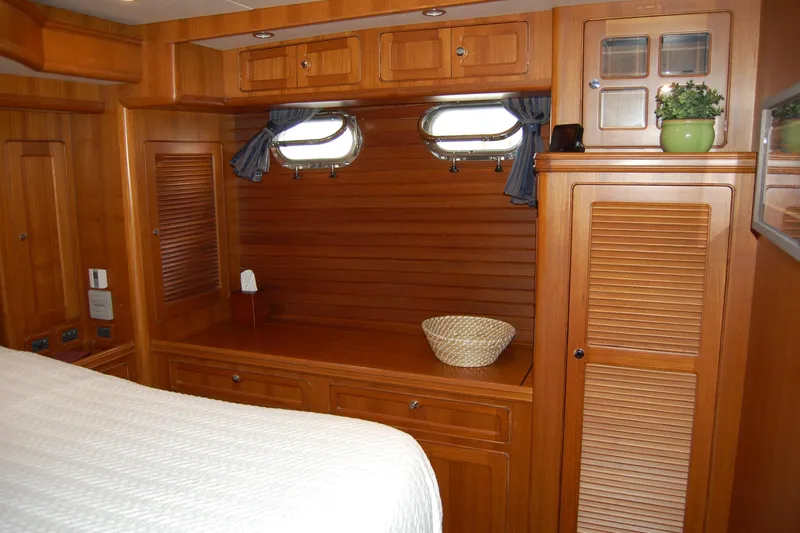Blue Red Yacht Photos Pics Interior of 2006 Selene Pilothouse Ocean Trawler with wooden cabinetry and porthole windows.