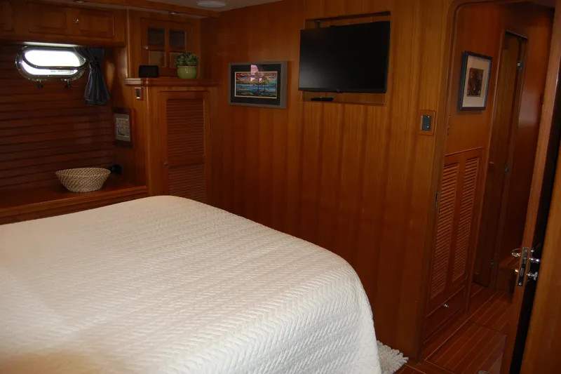 Blue Red Yacht Photos Pics Cozy cabin interior of 2006 Selene Pilothouse Ocean Trawler with wood paneling and TV.