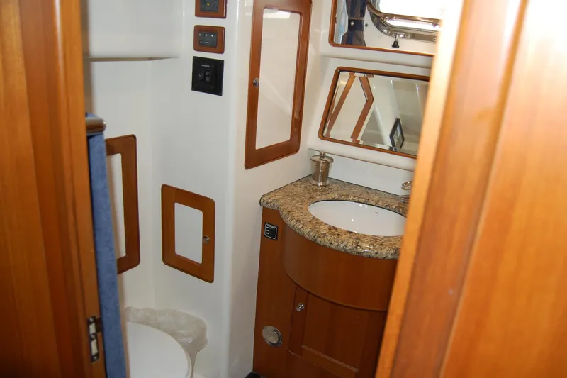 Blue Red Yacht Photos Pics 2006 Selene Pilothouse Ocean Trawler bathroom with granite countertop and wooden cabinetry.