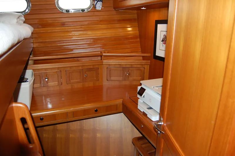 Blue Red Yacht Photos Pics Cozy wooden interior of 2006 Selene Pilothouse Ocean Trawler with desk and storage.