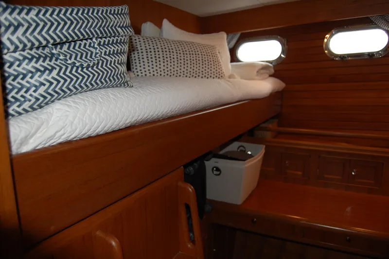 Blue Red Yacht Photos Pics 2006 Selene Pilothouse Ocean Trawler cabin with wooden interior and cozy bedding.