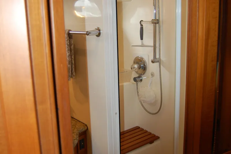 Blue Red Yacht Photos Pics Shower area in 2006 Selene Pilothouse Ocean Trawler with wooden seat and chrome fixtures.