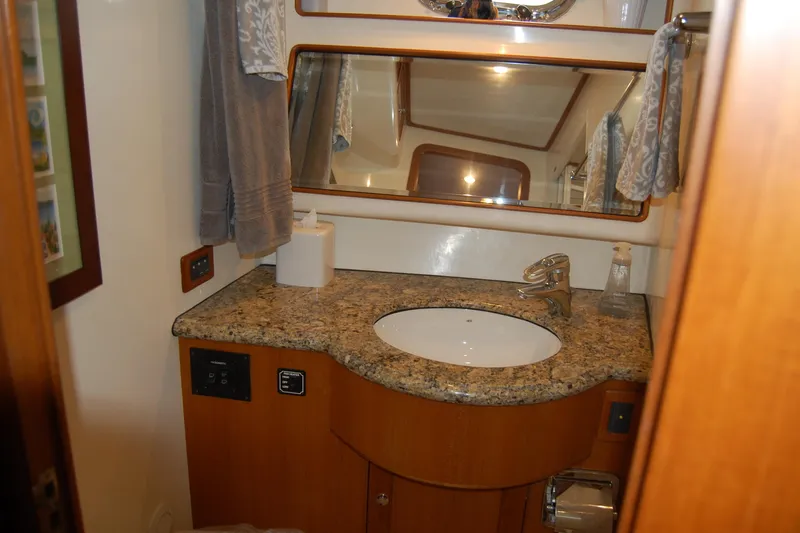 Blue Red Yacht Photos Pics Luxurious bathroom in 2006 Selene Pilothouse Ocean Trawler with granite countertop and modern fixtures.