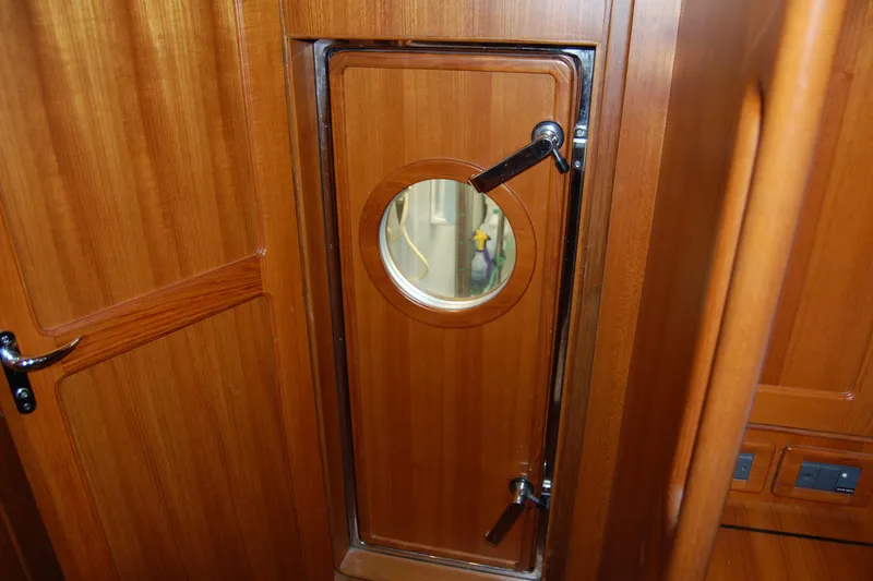 Blue Red Yacht Photos Pics Wooden interior door with porthole on 2006 Selene Pilothouse Ocean Trawler.