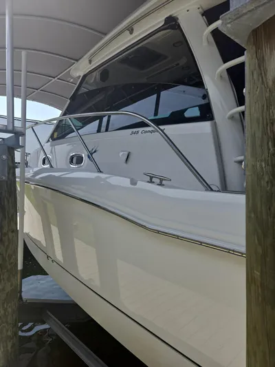  Yacht Photos Pics 2016 Boston Whaler 345 Conquest boat docked under a canopy.
