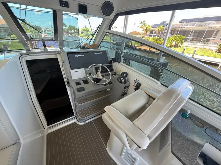 Yacht Photos Pics 2016 Boston Whaler 345 Conquest helm with steering wheel and navigation screens.