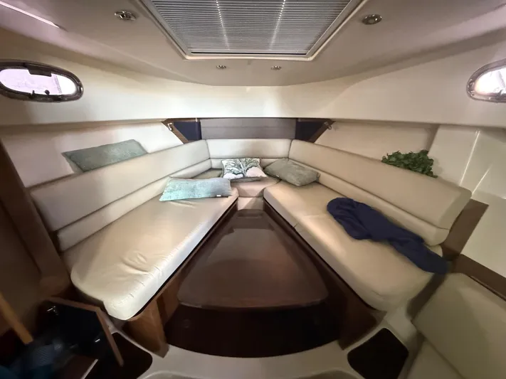  Yacht Photos Pics 2016 Boston Whaler 345 Conquest cabin interior with beige seating and cushions.
