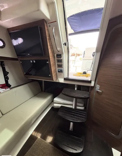  Yacht Photos Pics Interior of 2016 Boston Whaler 345 Conquest with stairs, seating, and TV.