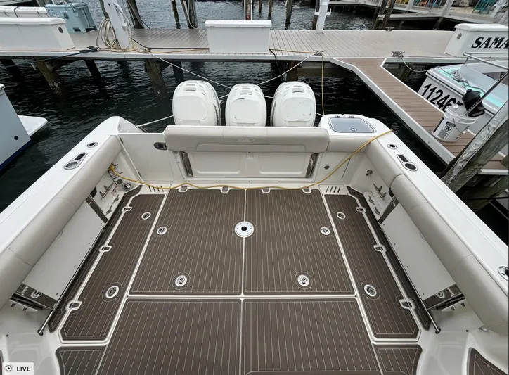  Yacht Photos Pics 2016 Boston Whaler 345 Conquest boat deck with triple outboard engines at dock.