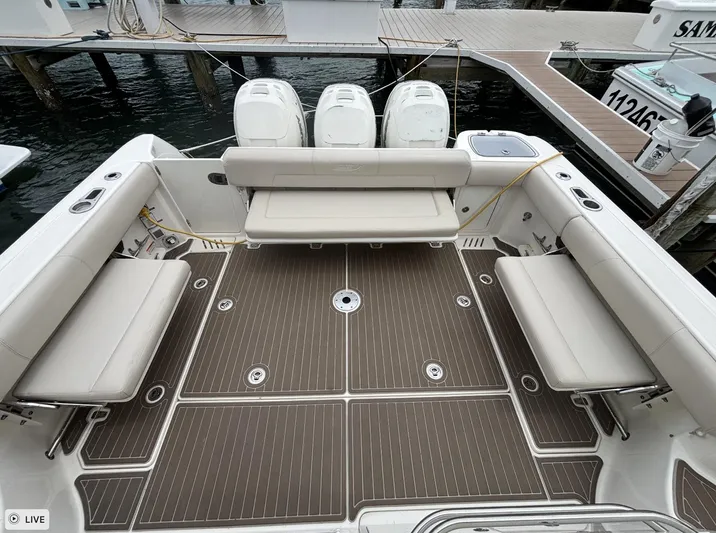  Yacht Photos Pics 2016 Boston Whaler 345 Conquest boat deck with seating and triple engines at dock.