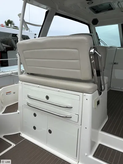  Yacht Photos Pics 2016 Boston Whaler 345 Conquest interior with cushioned seating and storage drawers.