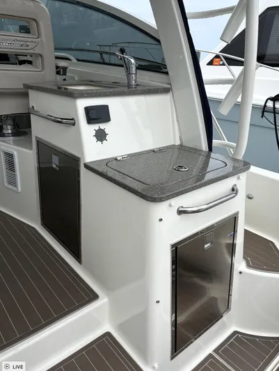  Yacht Photos Pics Boston Whaler 345 Conquest 2016 boat galley with sink and storage cabinets.