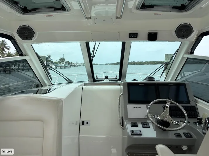  Yacht Photos Pics Interior view of 2016 Boston Whaler 345 Conquest helm with dual screens and steering wheel.
