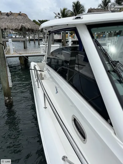 Yacht Photos Pics 2016 Boston Whaler 345 Conquest docked at marina, side view.