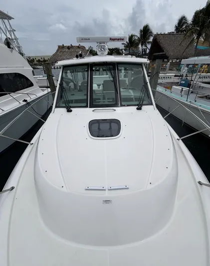  Yacht Photos Pics 2016 Boston Whaler 345 Conquest boat docked, featuring sleek design and advanced navigation equipment.