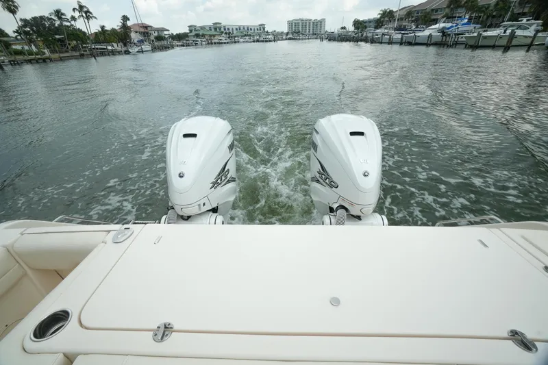  Yacht Photos Pics 2019 Grady-White Canyon 336 boat with dual outboard engines on a waterway.