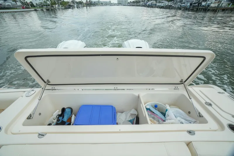  Yacht Photos Pics 2019 Grady-White Canyon 336 boat storage compartment with open lid, showing various items inside.