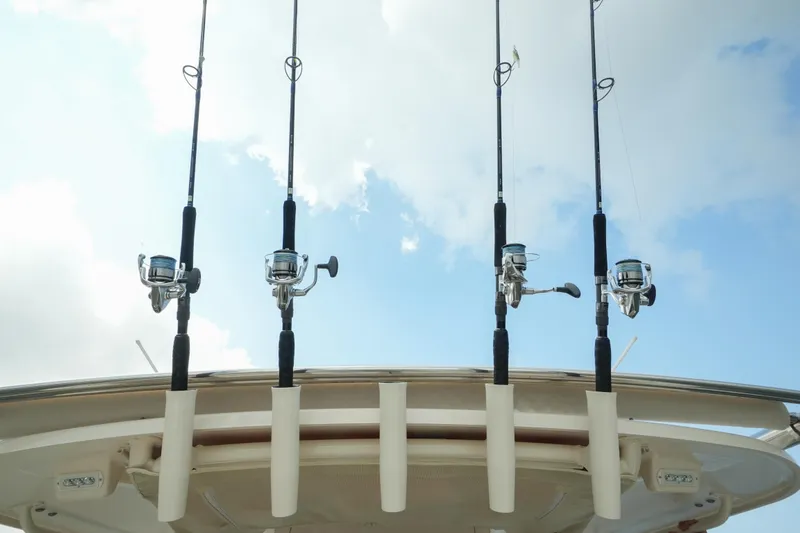  Yacht Photos Pics Fishing rods on a 2019 Grady-White Canyon 336 boat against a cloudy sky.