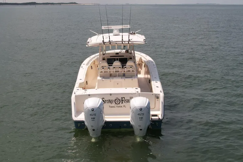  Yacht Photos Pics 2019 Grady-White Canyon 336 boat on calm water, rear view with dual engines.