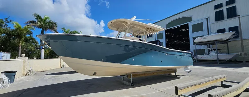  Yacht Photos Pics 2019 Grady-White Canyon 336 boat displayed outdoors near a large building.