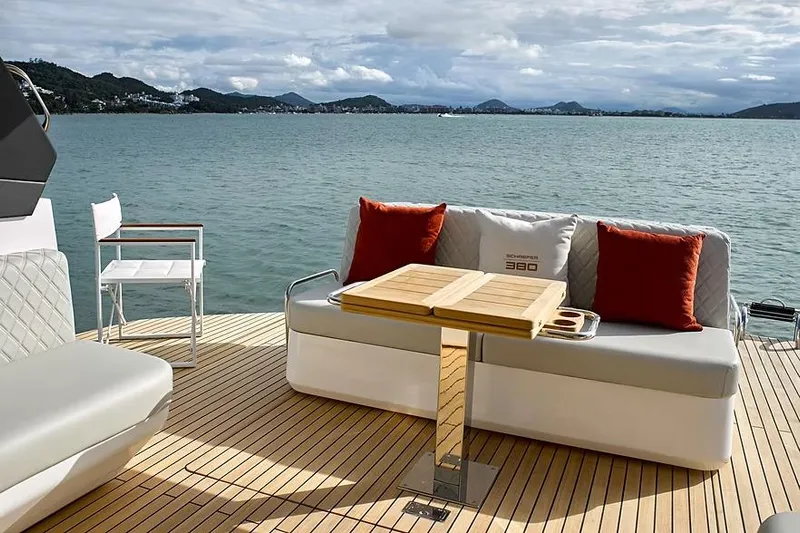  Yacht Photos Pics Manufacturer Provided Image: Luxury Schaefer 380 yacht deck with seating, table, and scenic water view, 2025 model.