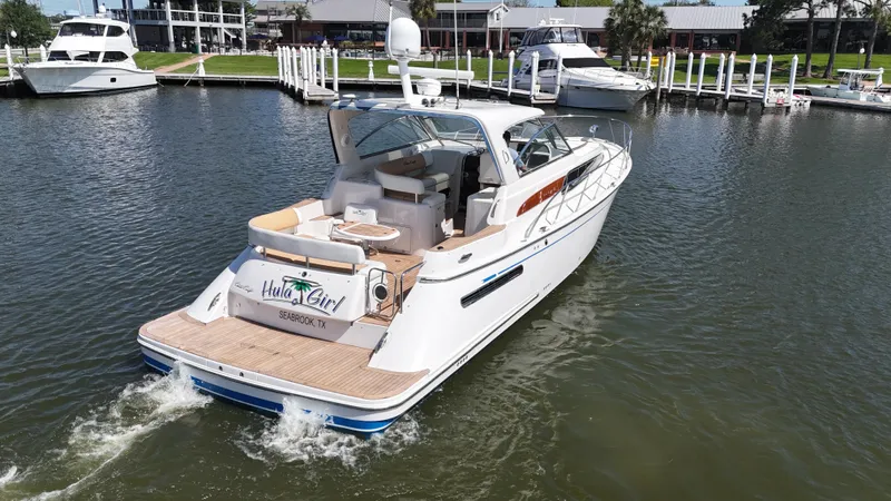 Hula Girl Yacht Photos Pics 2007 Chris-Craft Roamer 40 yacht cruising in a marina, showcasing elegant design and luxury.