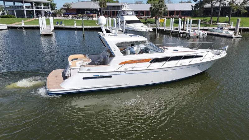 Hula Girl Yacht Photos Pics 2007 Chris-Craft Roamer 40 yacht cruising in a marina, showcasing sleek design and luxury.