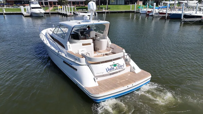 Hula Girl Yacht Photos Pics 2007 Chris-Craft Roamer 40 yacht cruising in a marina, showcasing elegant design and luxury.