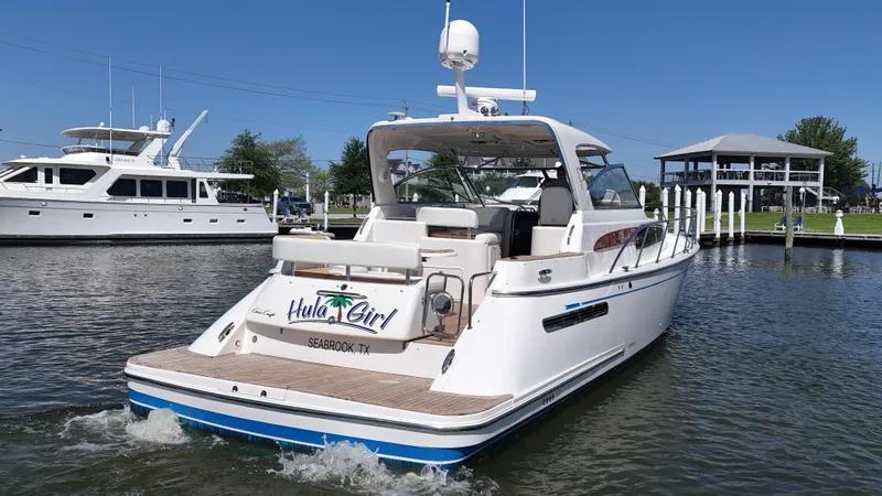 Hula Girl Yacht Photos Pics 2007 Chris-Craft Roamer 40 yacht on water, rear view, sunny day, marina background.