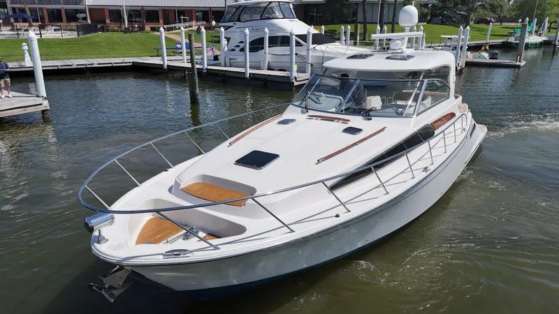 Hula Girl Yacht Photos Pics 2007 Chris-Craft Roamer 40 yacht docked in a marina, showcasing sleek design and luxury features.