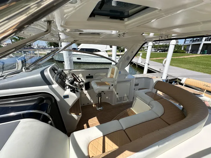 Hula Girl Yacht Photos Pics 2007 Chris-Craft Roamer 40 yacht interior with helm and seating area at dock.