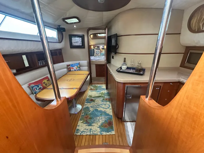 Hula Girl Yacht Photos Pics 2007 Chris-Craft Roamer 40 interior with dining area, kitchenette, and cozy seating.
