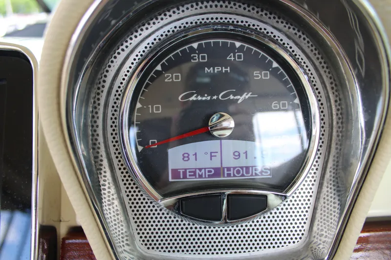 America Yacht Photos Pics Close-up of 2023 Chris-Craft Launch 31 GT speedometer displaying temperature and hours.