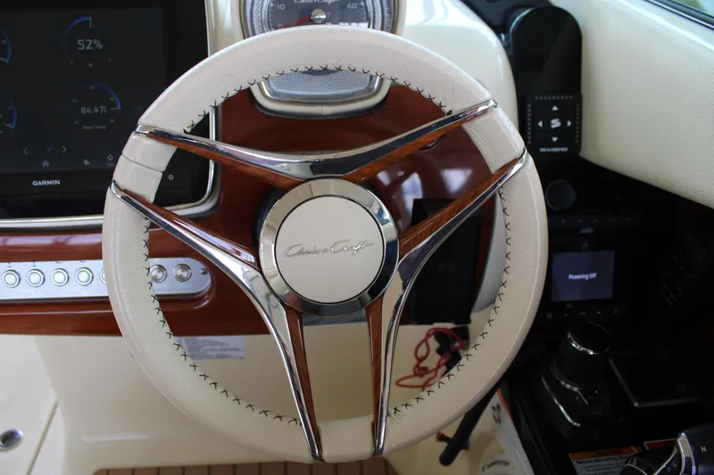 America Yacht Photos Pics Steering wheel of 2023 Chris-Craft Launch 31 GT with elegant design and modern controls.