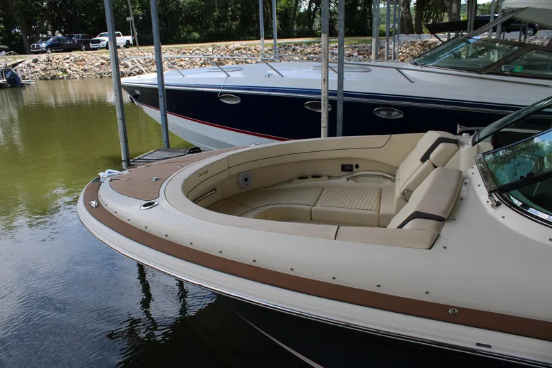 America Yacht Photos Pics 2023 Chris-Craft Launch 31 GT boat docked, featuring elegant seating and sleek design.