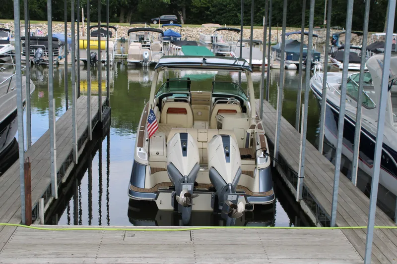 America Yacht Photos Pics 2023 Chris-Craft Launch 31 GT docked at marina, rear view with dual engines.