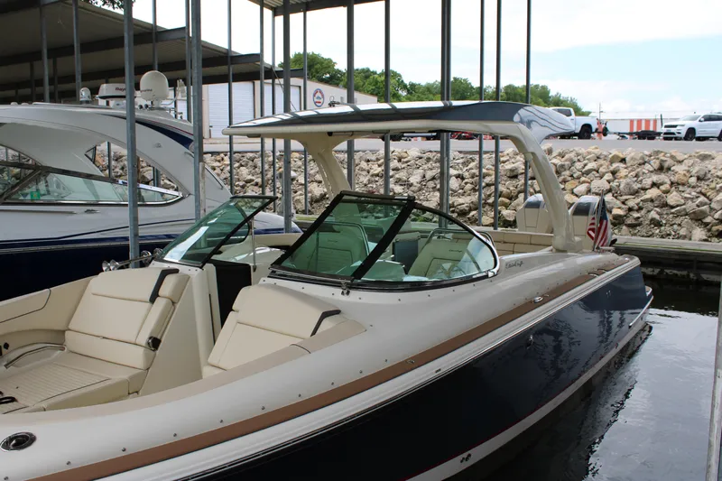 America Yacht Photos Pics 2023 Chris-Craft Launch 31 GT boat docked, featuring sleek design and luxurious seating.