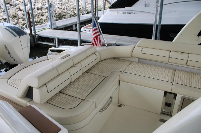 America Yacht Photos Pics 2023 Chris-Craft Launch 31 GT boat interior with luxurious beige seating and American flag.