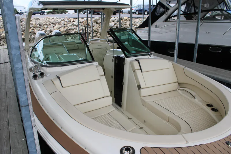 America Yacht Photos Pics 2023 Chris-Craft Launch 31 GT boat with luxurious seating in a marina.