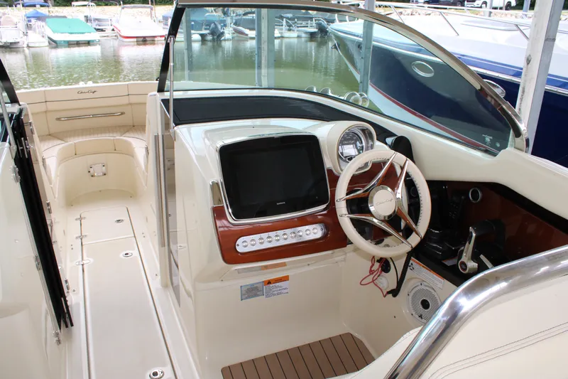 America Yacht Photos Pics 2023 Chris-Craft Launch 31 GT boat interior with steering wheel and dashboard.