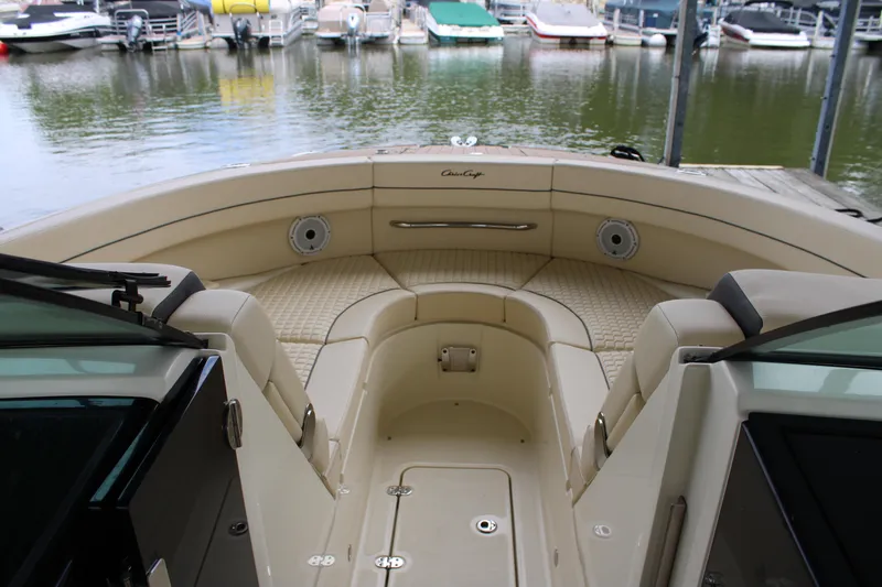America Yacht Photos Pics 2023 Chris-Craft Launch 31 GT boat interior with beige seating at a marina.